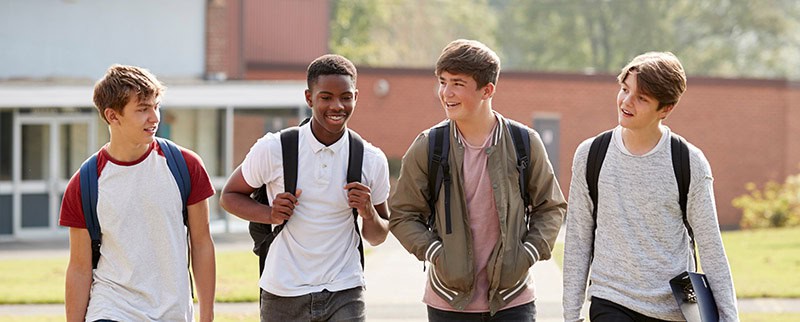 Group Of Male Teenage Students Walking Around College Campus Pass It On Boys - job posting